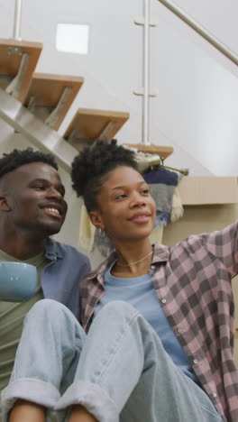 video of happy african american couple taking selfie after moving into new house