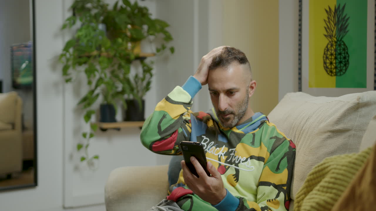 hombre decepcionado lee noticias en su teléfono inteligente, frustrado por la información