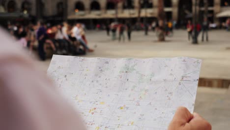 man tourist using smart phone searching location in map application online close up macro. backpacker using gps to find destination on vacation. city or forest hiking, walking in europe