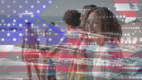 animación de la bandera de los ee.uu. sobre amigos diversos felices en la playa en verano