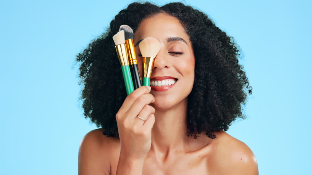 Beauty, makeup brush and face of woman in studio
