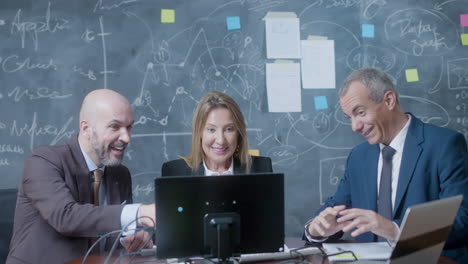 business partners sitting at table in boardroom