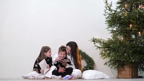 happy young family spends time together near the christmas tree during the christmas holidays family happy young family spends time together near the christmas tree during the christmas holidays family values