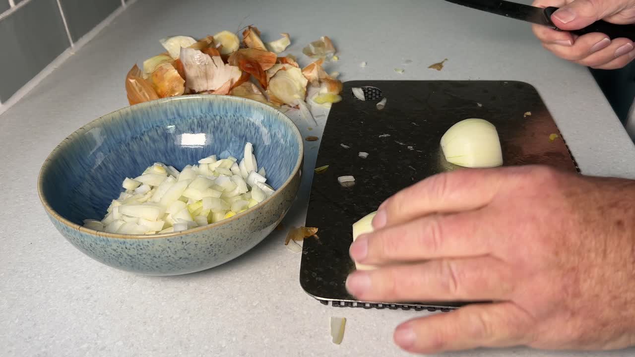 Cutting onions into smaller portions for a recipe