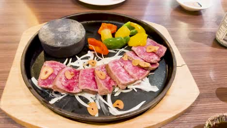 beef slices cooking on a hot stone plate