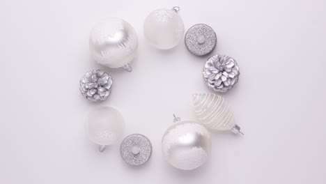 white balls silver pine cone and artificial candles make a christmas wreath and change places