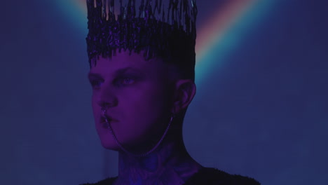 man with gothic crown in dark studio