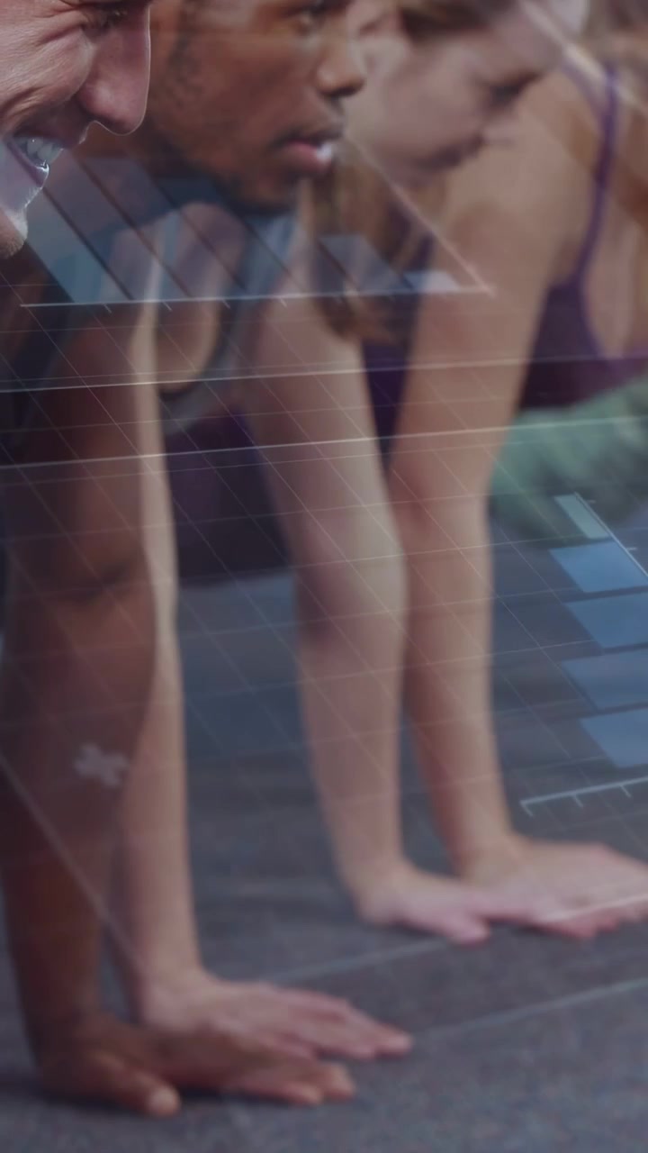 Vertical video: Group training leaning forward and starting push-ups in gym, showing hands on floor