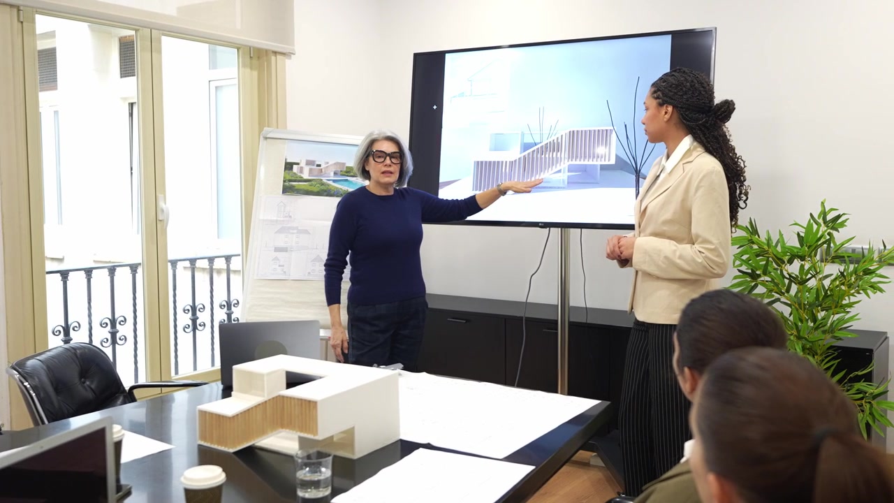 Architect Presenting Building Design to Business Team in Conference Room
