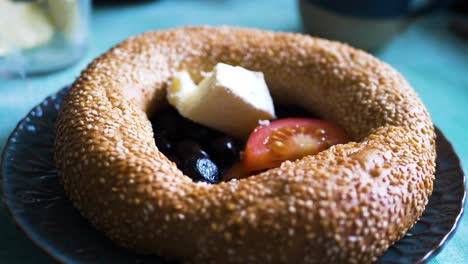 closeup of simit with butter and tomato, a turkish breakfast bread bagel