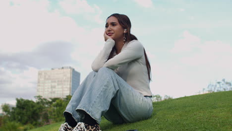 Lonely-woman-sitting-on-grass