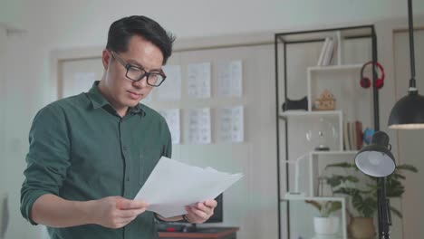 man reading documents in office