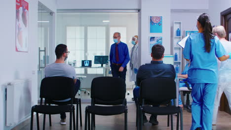 Nurse-and-senior-patient-going-in-consultation-room