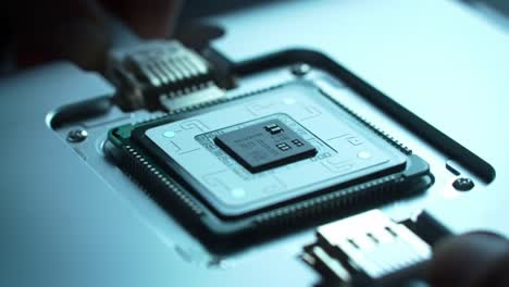 experts are assembling a microprocessor in a high-tech research lab, highlighting precise techniques and equipment used in modern computing innovations.