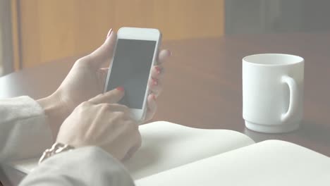 video of women using smartphone and drinking coffee in the cafe