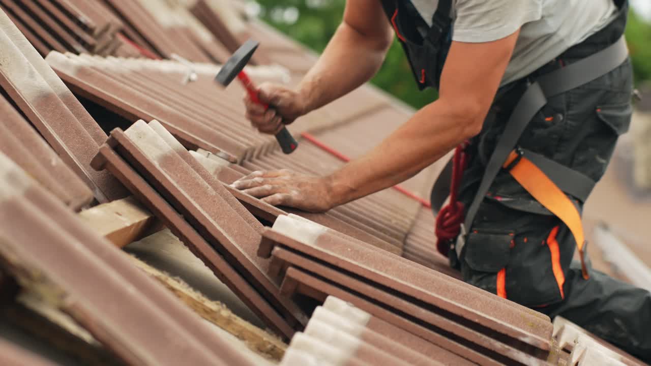 Solar panel installation, roofer putting back roof tiles after adding mount