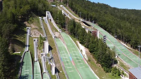 planica nordic centre at planica, slovenia - aerial drone view of ski jumping hills where athletes train for winter sports and olympics