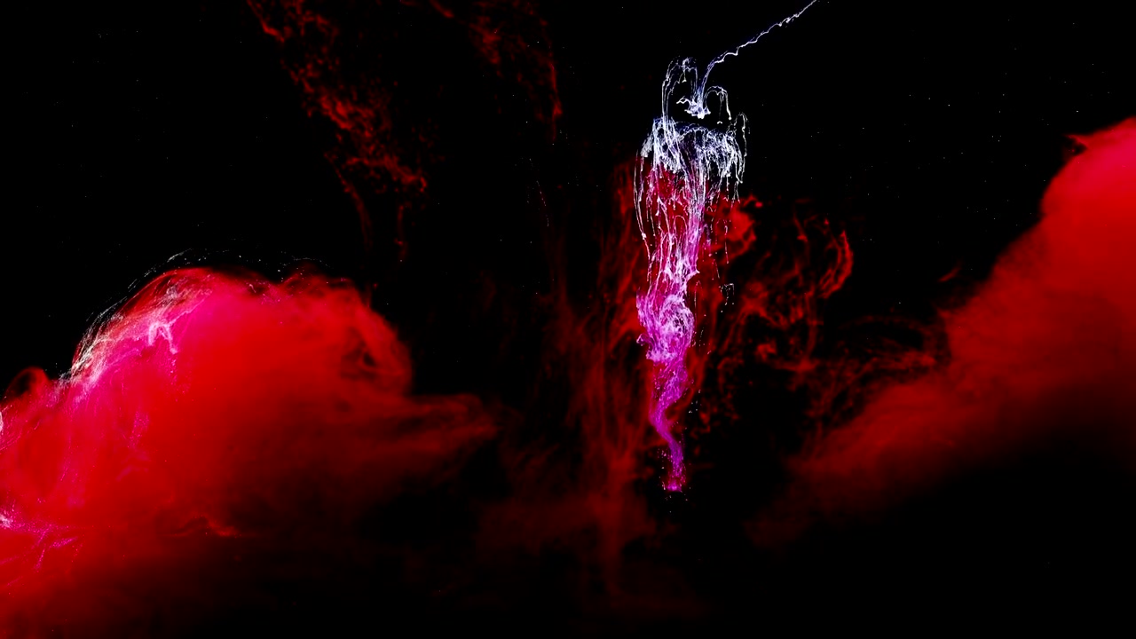 Abstract forms. Shooting on a black background. Mixing of paints.
