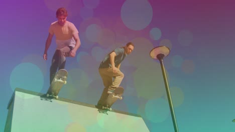 animation of colourful spots over caucasian men skateboarding