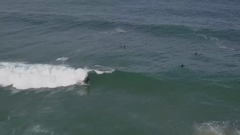 man surfer surfing big ocean waves drone aerial shot