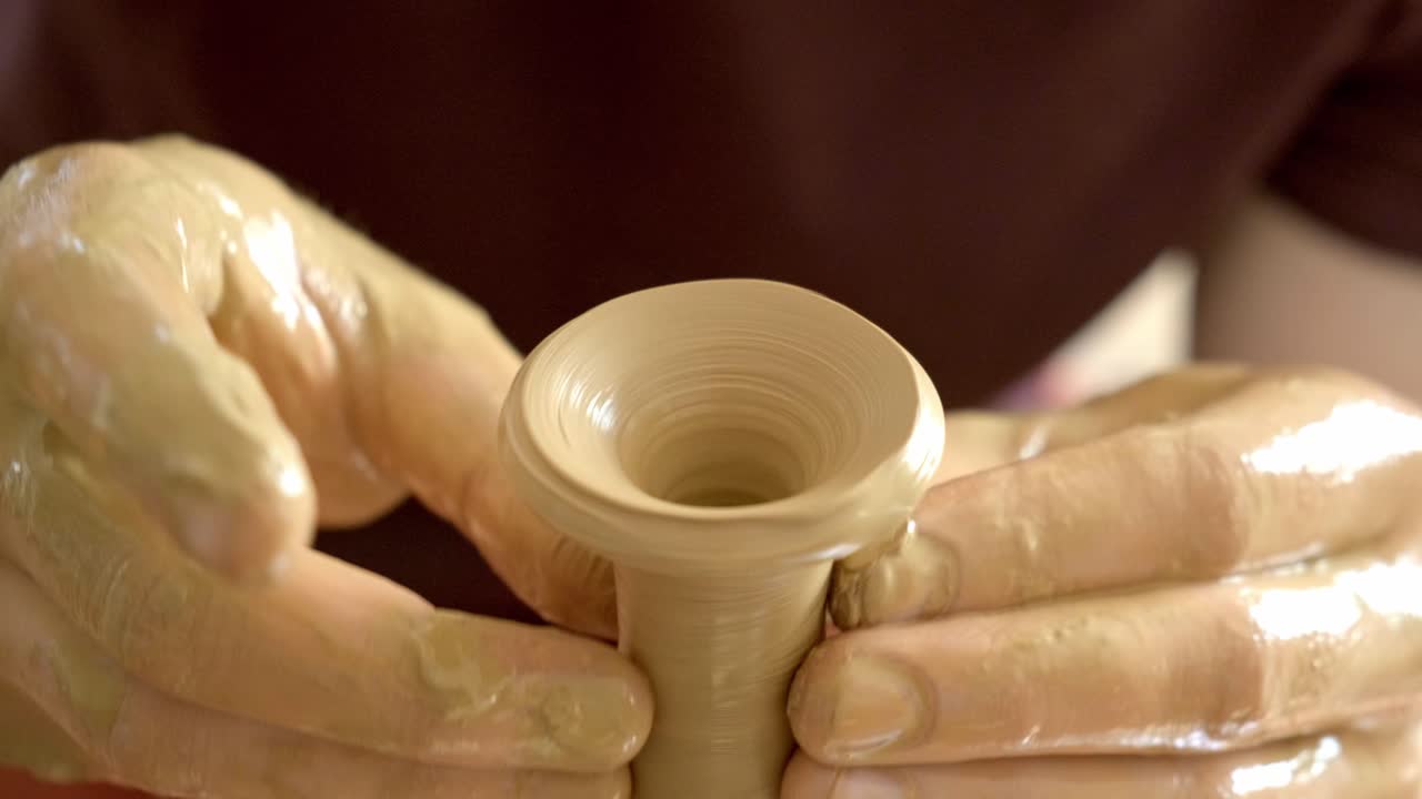 Hands Shaping Pottery on a Wheel