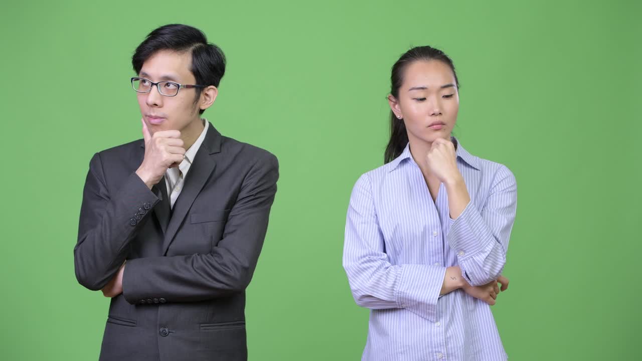 Young Asian business couple thinking together