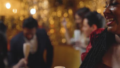 Pull-Focus-Shot-of-Friends-Dancing-In-a-Bar