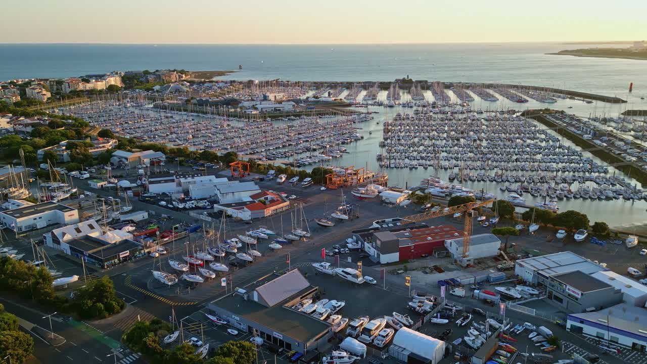 Forward panoramic drone movement to the Port des Minimes of La Rochelle main harbor site on sunset, Charente-Maritime, France
