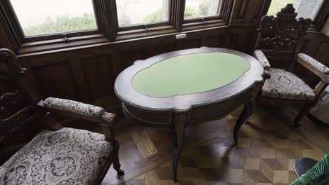 antique oval table with chairs in a luxurious room