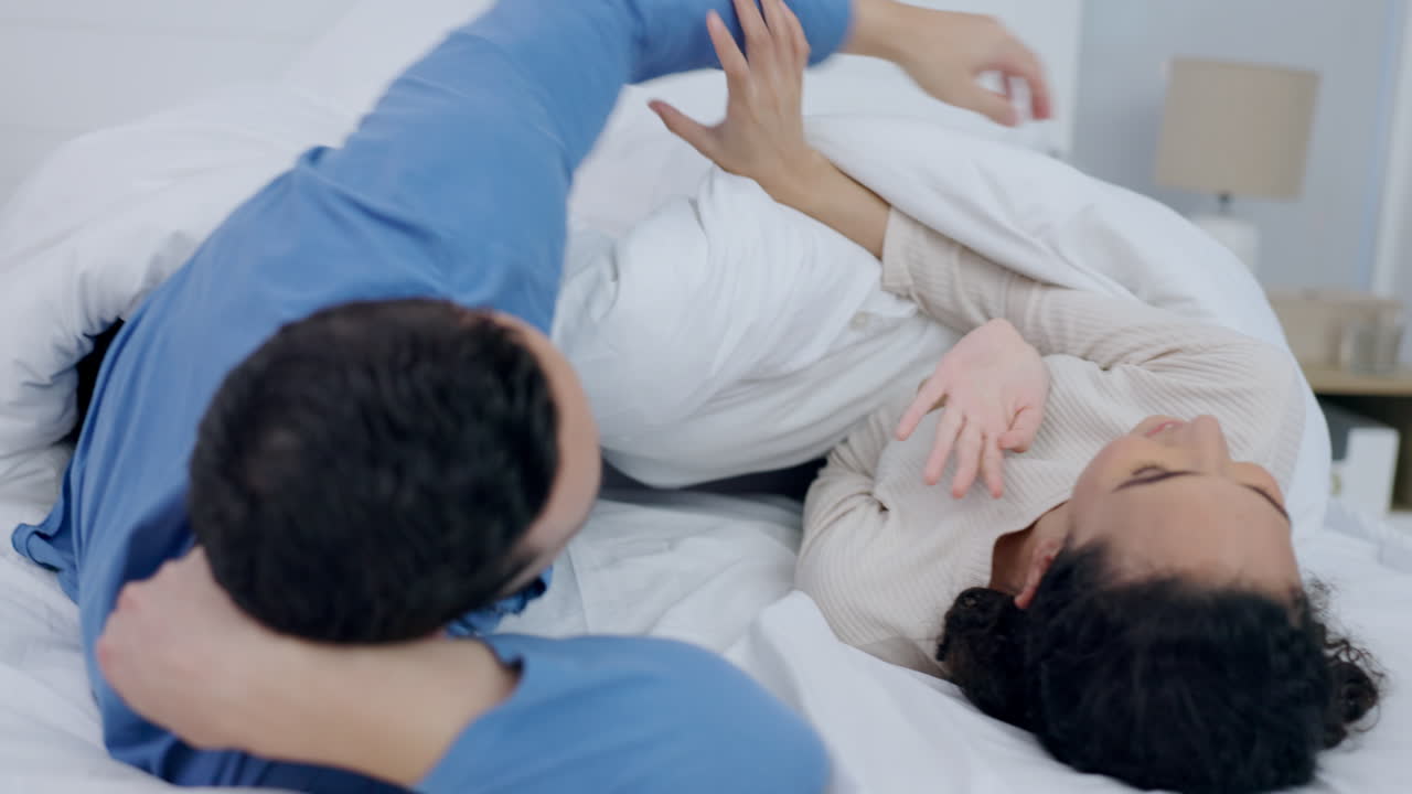 Couple, playing in bed and happy in morning