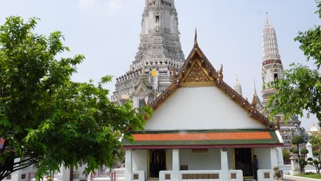 A-gorgeous-shot-of-Wat-Arun-and-the-garden-around-the-temple-in-Bangkok-on-a-clear-blue-day-in-the-capital-of-Thailand