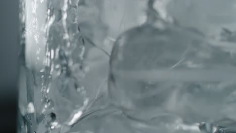 pouring water into a frosty glass with ice