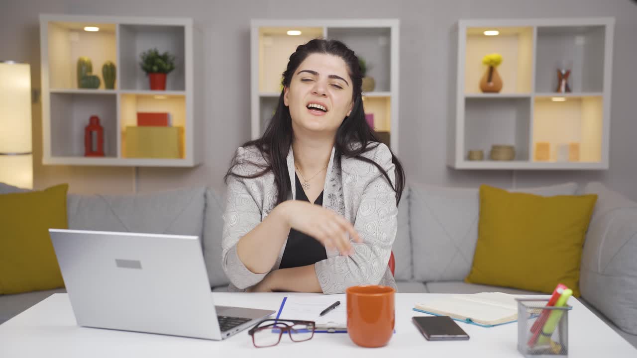 Home office worker woman making cute gesture at camera.