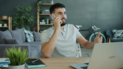 man having a phone call in home office
