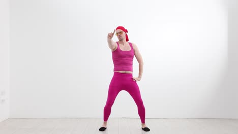 humorous man in pink outfit dancing and posing