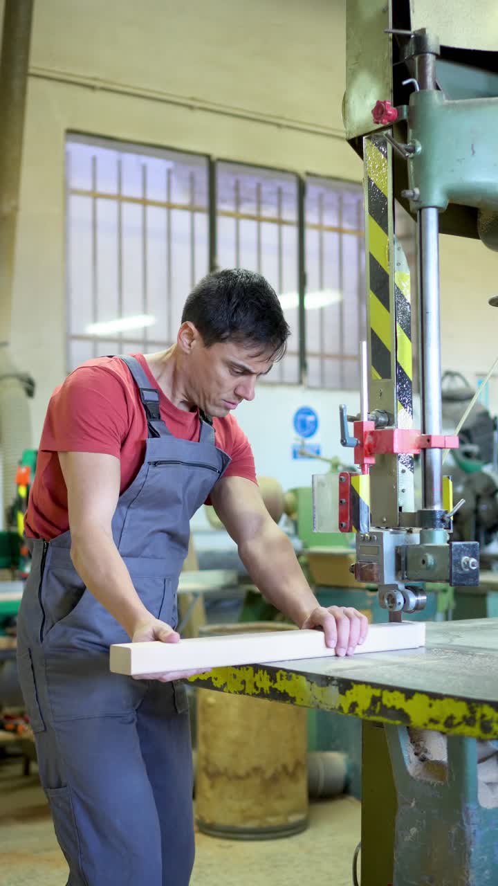 Man operating a woodworking machine in a carpentry workshop