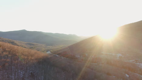 Aerial-cinematic-pan-right-motion-sunrise-first-light-fade-of-mountain-landscape,-East-Branch-Pemigewasset-River-and-forest-at-Loon-Mountain-Resort-New-Hampshire