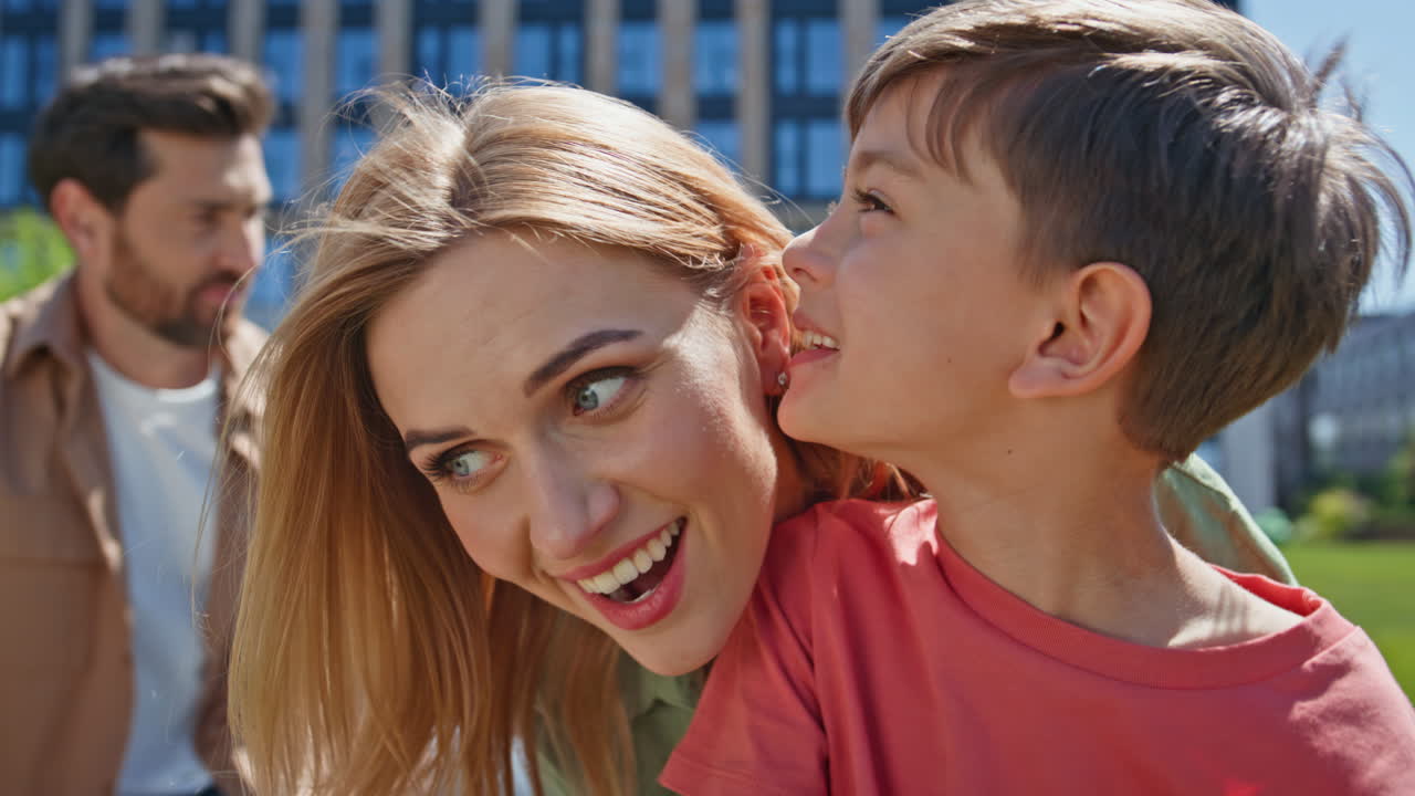 Mother spending time child boy in park closeup. Son and mom talking at picnic