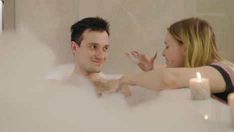 una pareja disfrutando de un baño de burbujas.