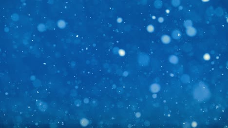 white winter flakes dance in abstract vibrant blue cinematic snowfall