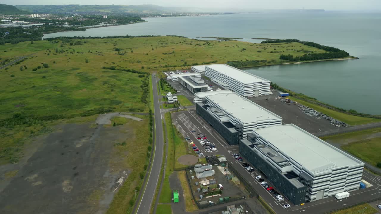 Left-to-ritght passing aerial video GV of Studio Ulster, a virtual production film studio in Belfast, Northern Ireland, UK. Filmed in 60FPS, 4K and with Rec709 color