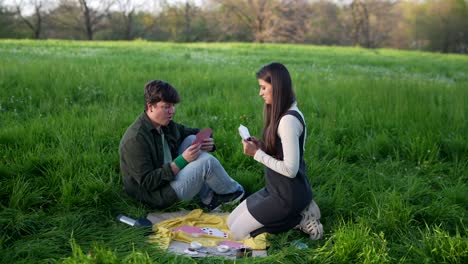 couple playing cards in a park