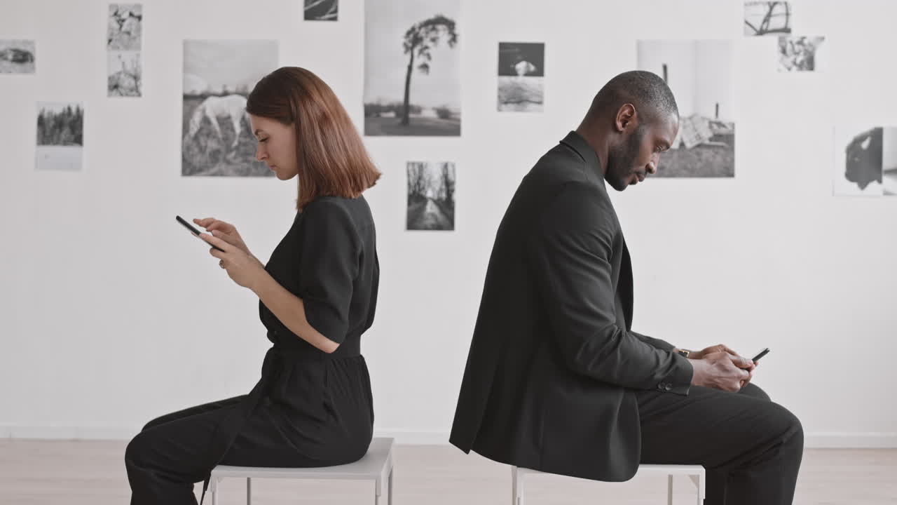 Couple Taking Pictures at Photography Exhibition