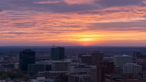 city skyline at sunset with colorful clouds