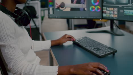 Close-up-of-african-video-editor-turning-head-looking-at-camera-smiling