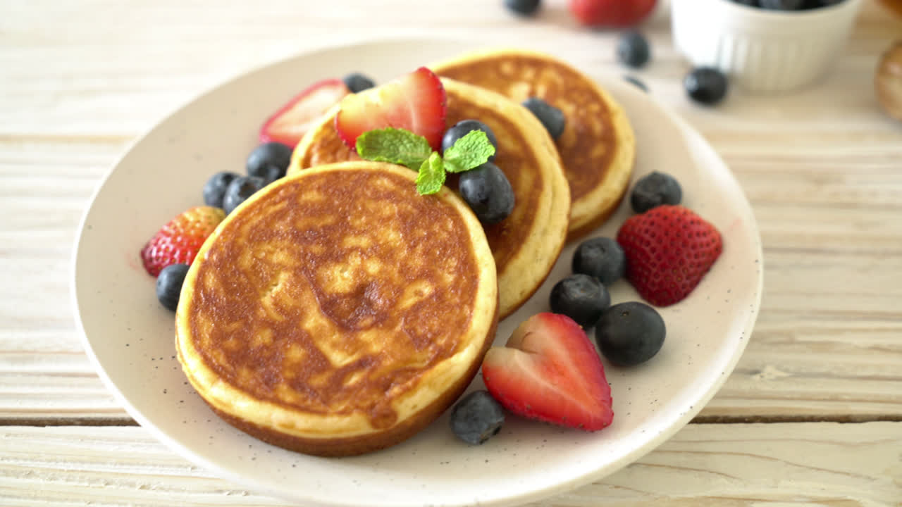 panqueque soufflé con arándanos frescos y fresas frescas