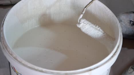 painting a wall with white paint