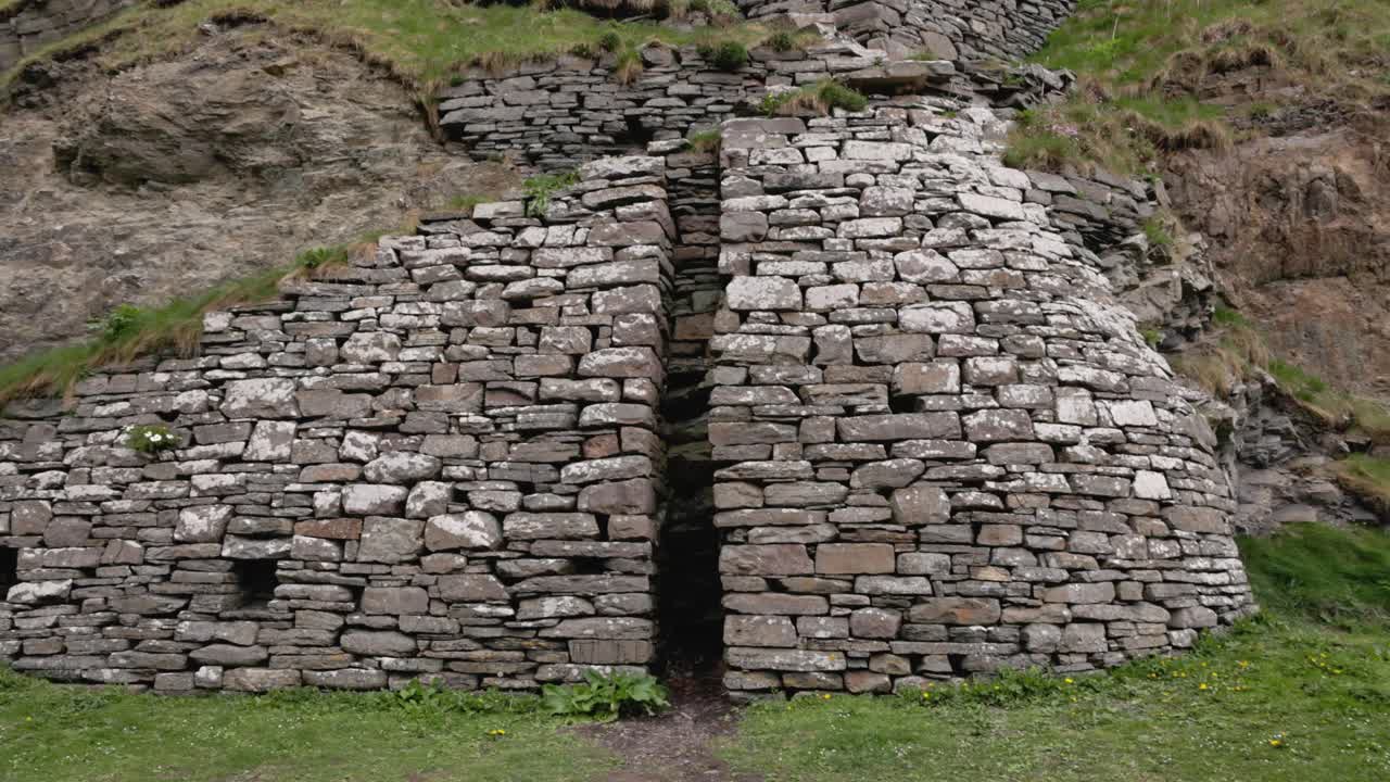 revealing shot of the mast rest in the stone used to build ships at Whaligoe