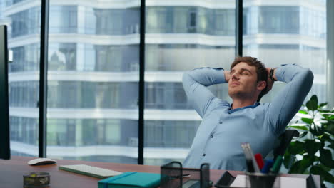 confident director having break on office chair. businessman relaxing enjoying