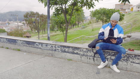 young boy using tablet outdoors